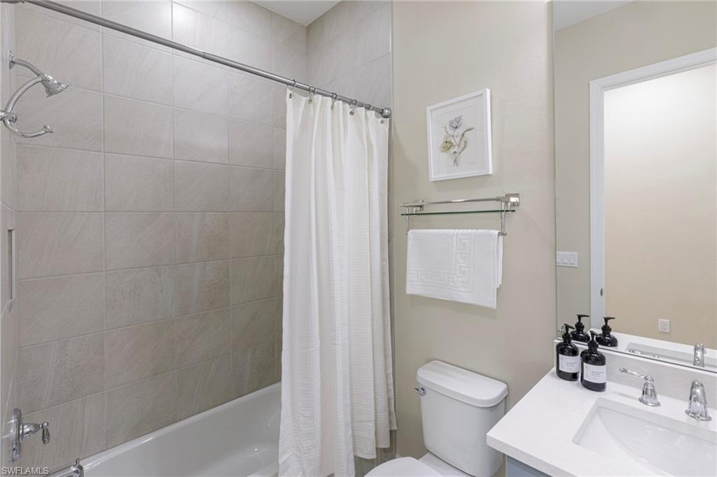 7184 Cayo Coco Lane Naples, FL 34113 - Photo 19 of 40 a bathroom with a toilet sink and shower