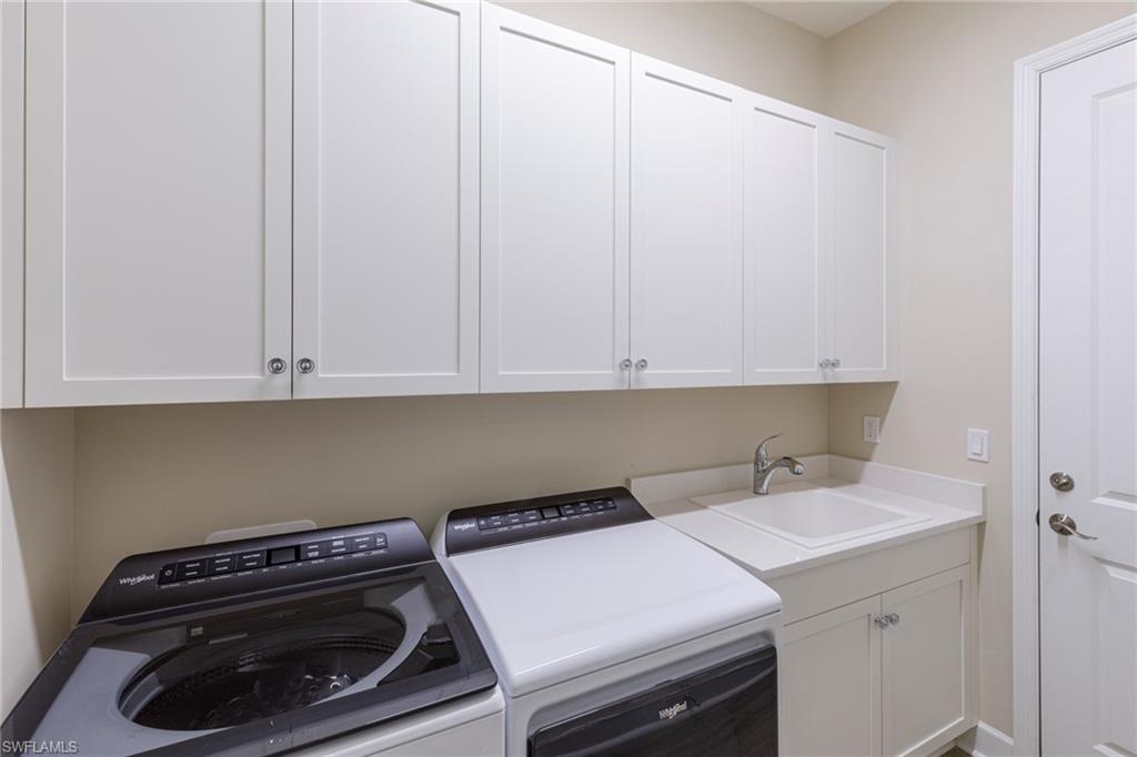 7184 Cayo Coco Lane Naples, FL 34113 - Photo 20 of 40 a utility room with dryer and washer