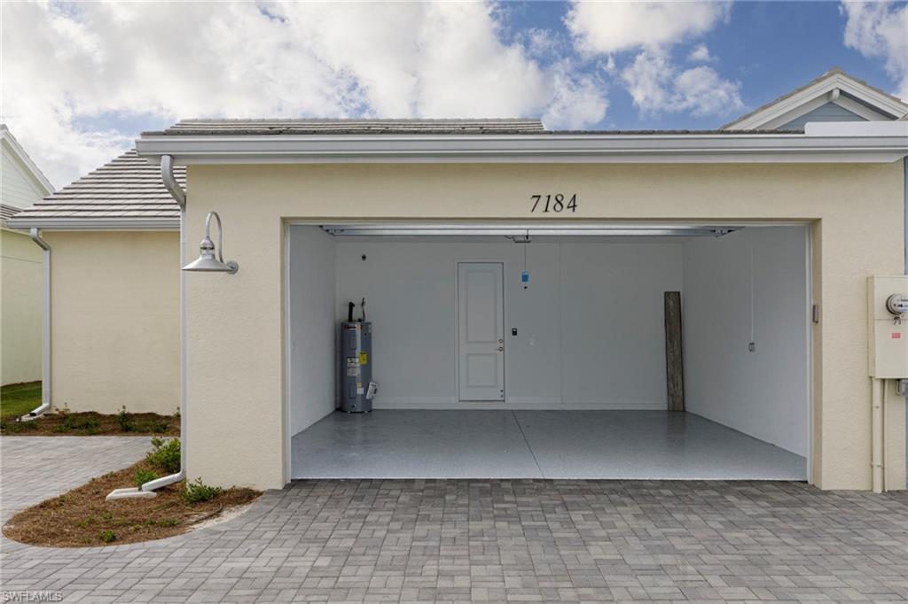 7184 Cayo Coco Lane Naples, FL 34113 - Photo 22 of 40 a view of a utility room with a cabinet