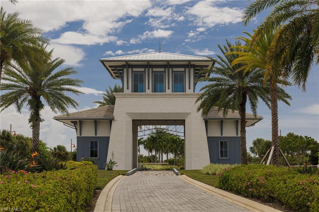 7184 Cayo Coco Lane Naples, FL 34113 - Photo 25 of 40 a front view of a house with a garden