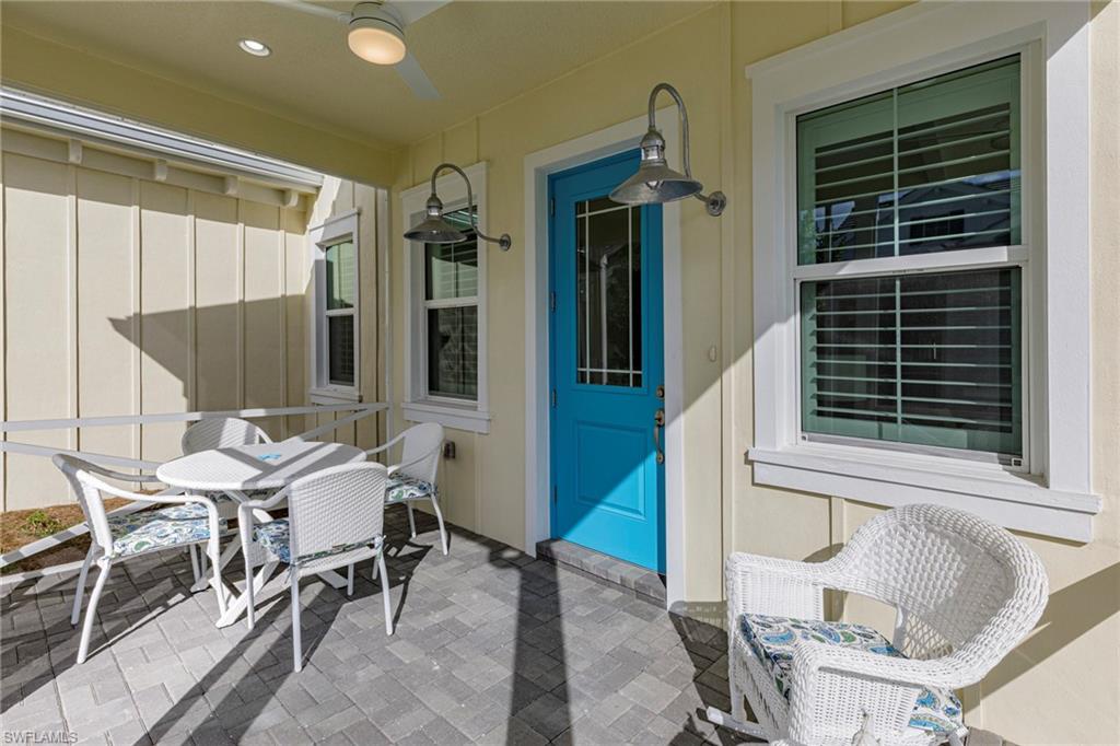 7184 Cayo Coco Lane Naples, FL 34113 - Photo 4 of 40 a view of a patio with table and chairs and potted plants