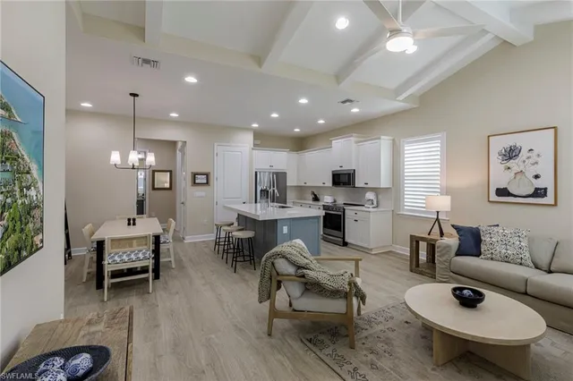 a living room with furniture and kitchen view