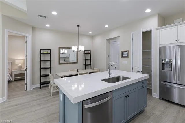 a kitchen with a sink and refrigerator