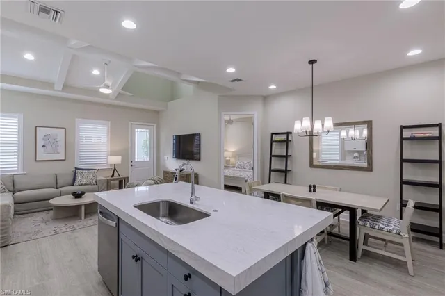 a large kitchen with a table chairs and a refrigerator
