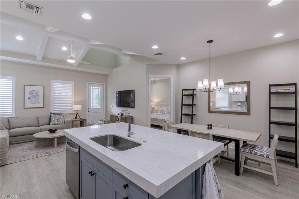 7184 Cayo Coco Lane Naples, FL 34113 - Photo 9 of 40 a large kitchen with a table chairs and a refrigerator