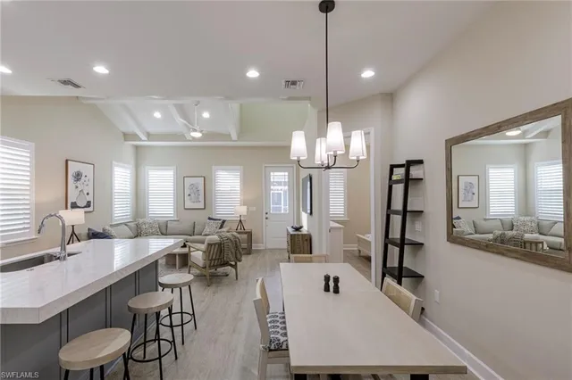 a large kitchen with a table and chairs