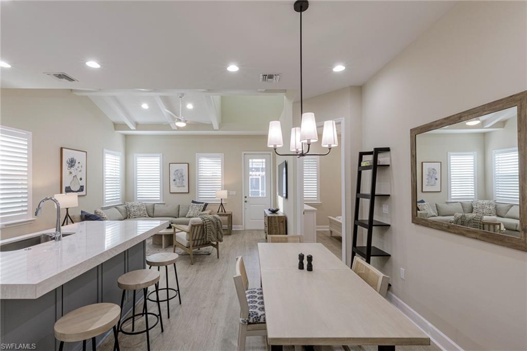 7184 Cayo Coco Lane Naples, FL 34113 - Photo 10 of 40 a large kitchen with a table and chairs
