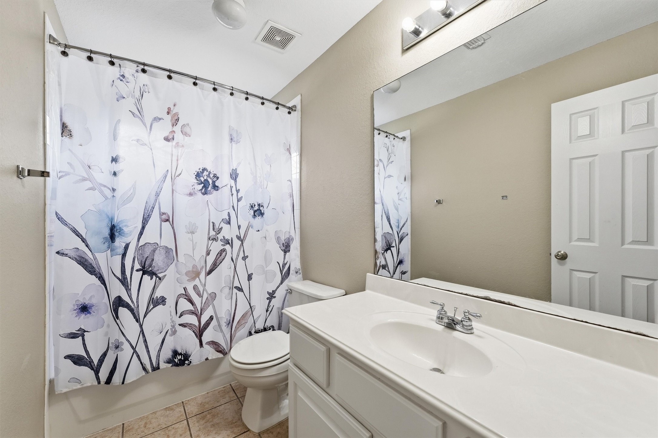 25181 Ramrock Drive Porter, TX 77365 - Photo 21 of 35 a bathroom with a shower curtain sink and a toilet