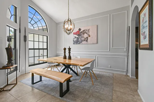 a living room with furniture a rug and a window