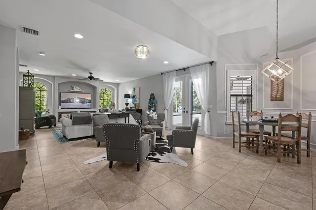a living room with furniture a dining table and chairs