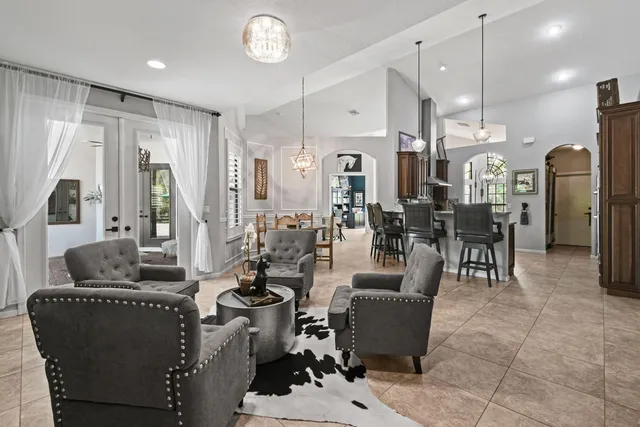 a living room with furniture and a chandelier