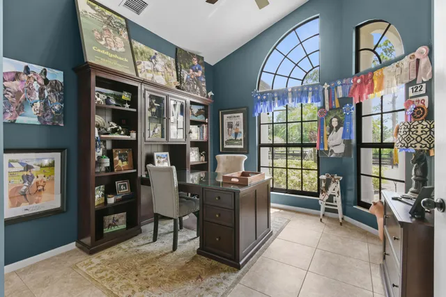 a spacious bedroom with a bed a dresser and mirror