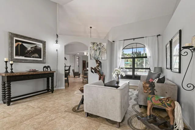 a living room with furniture a window and flat screen tv
