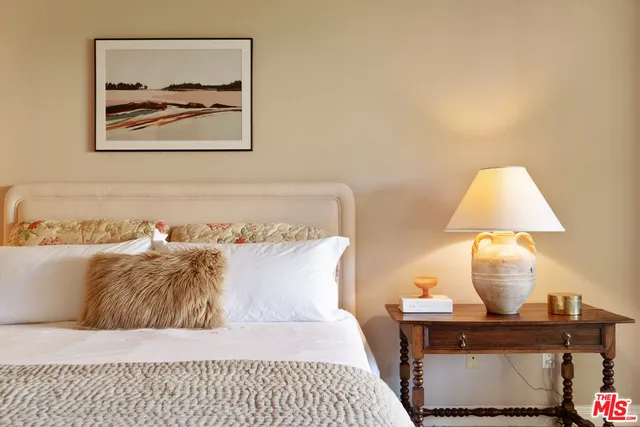 a bedroom with a bed and a lamp