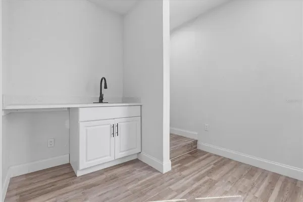 a view of a kitchen with wooden floor