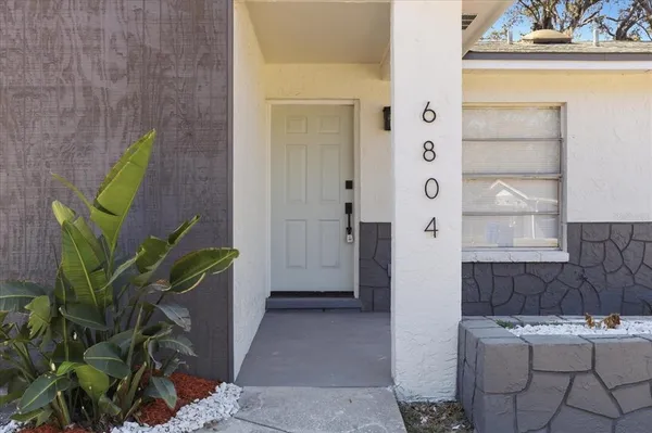 a bathroom with a sink a granite counter and a shower