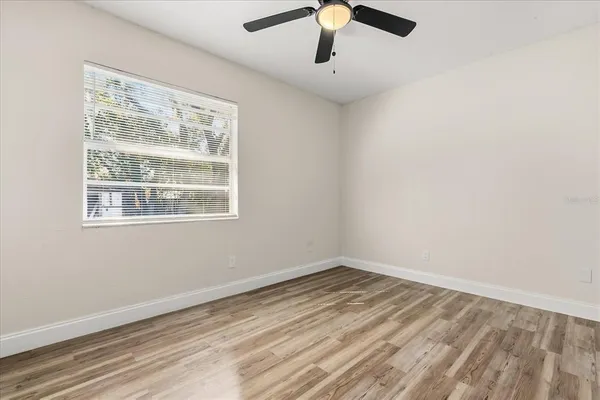 wooden floor in an empty room with a window