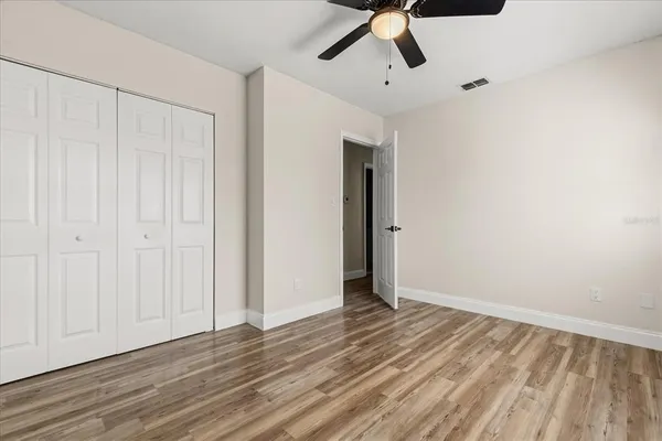 a view of an empty room with wooden floor