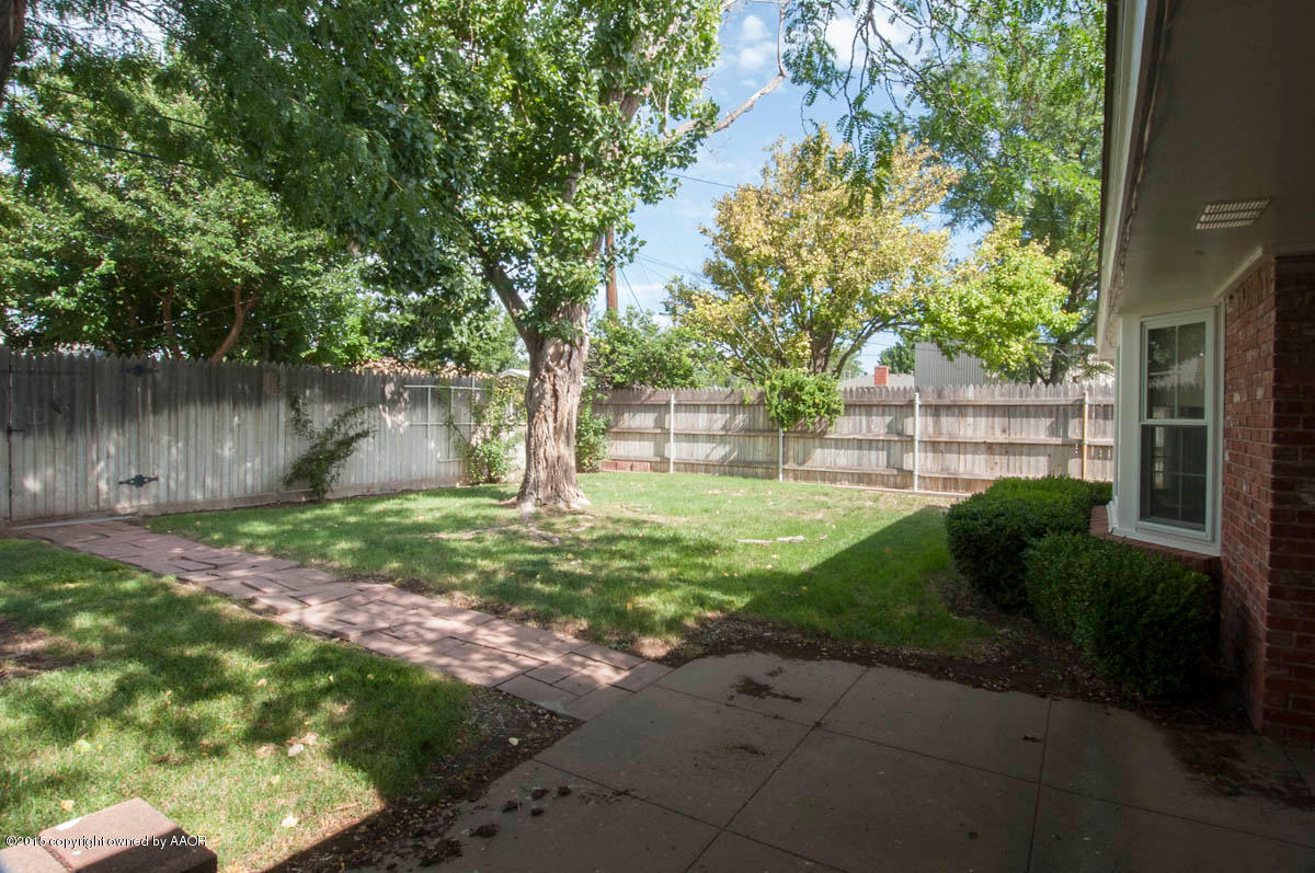 3306 Lombard Road Amarillo, TX 79106 - Photo 23 of 23 a view of a backyard with plants and a lake view