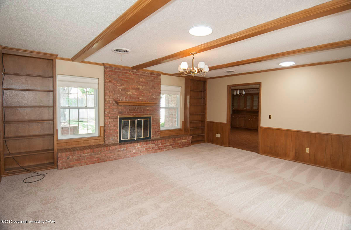 3306 Lombard Road Amarillo, TX 79106 - Photo 5 of 23 a view of an empty room with a fireplace and a window
