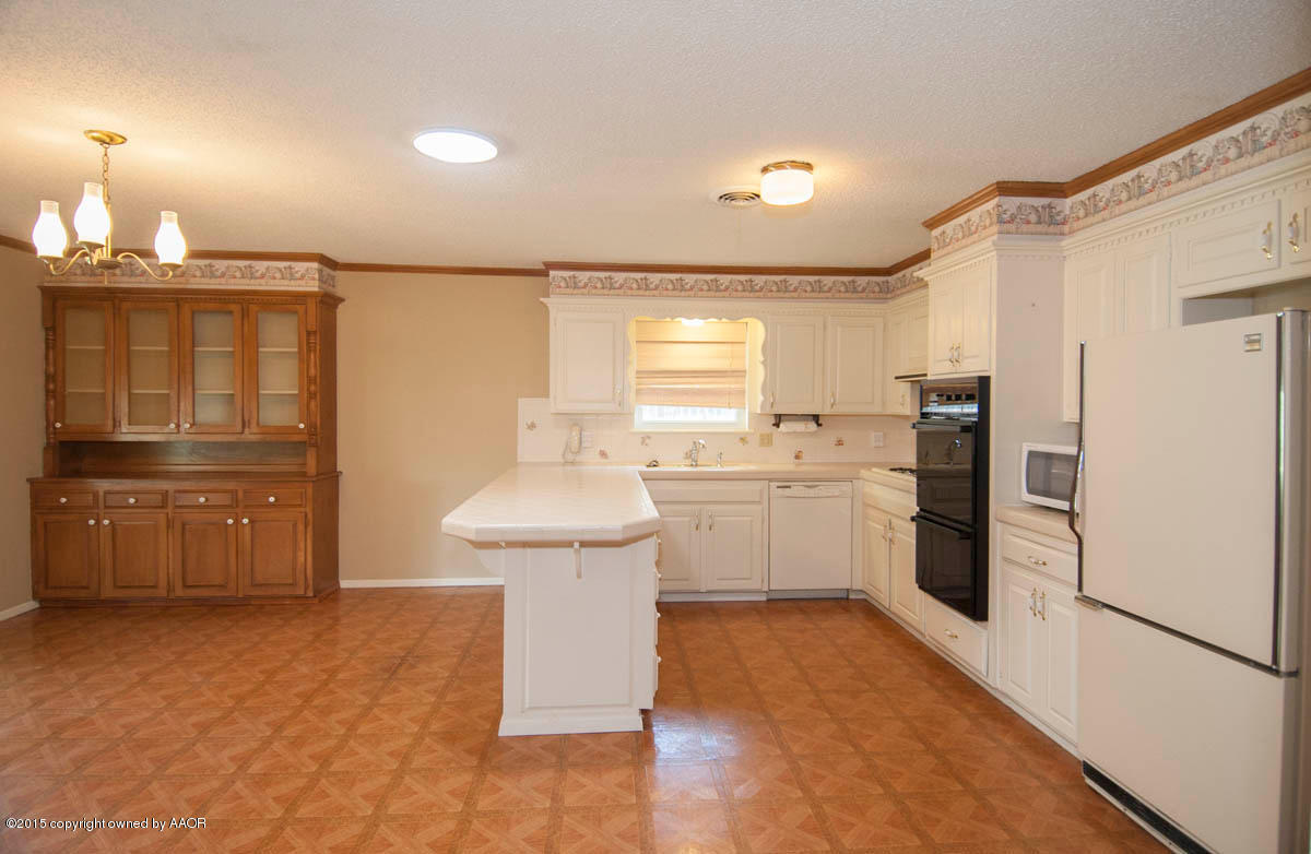 3306 Lombard Road Amarillo, TX 79106 - Photo 7 of 23 a kitchen with a sink and refrigerator
