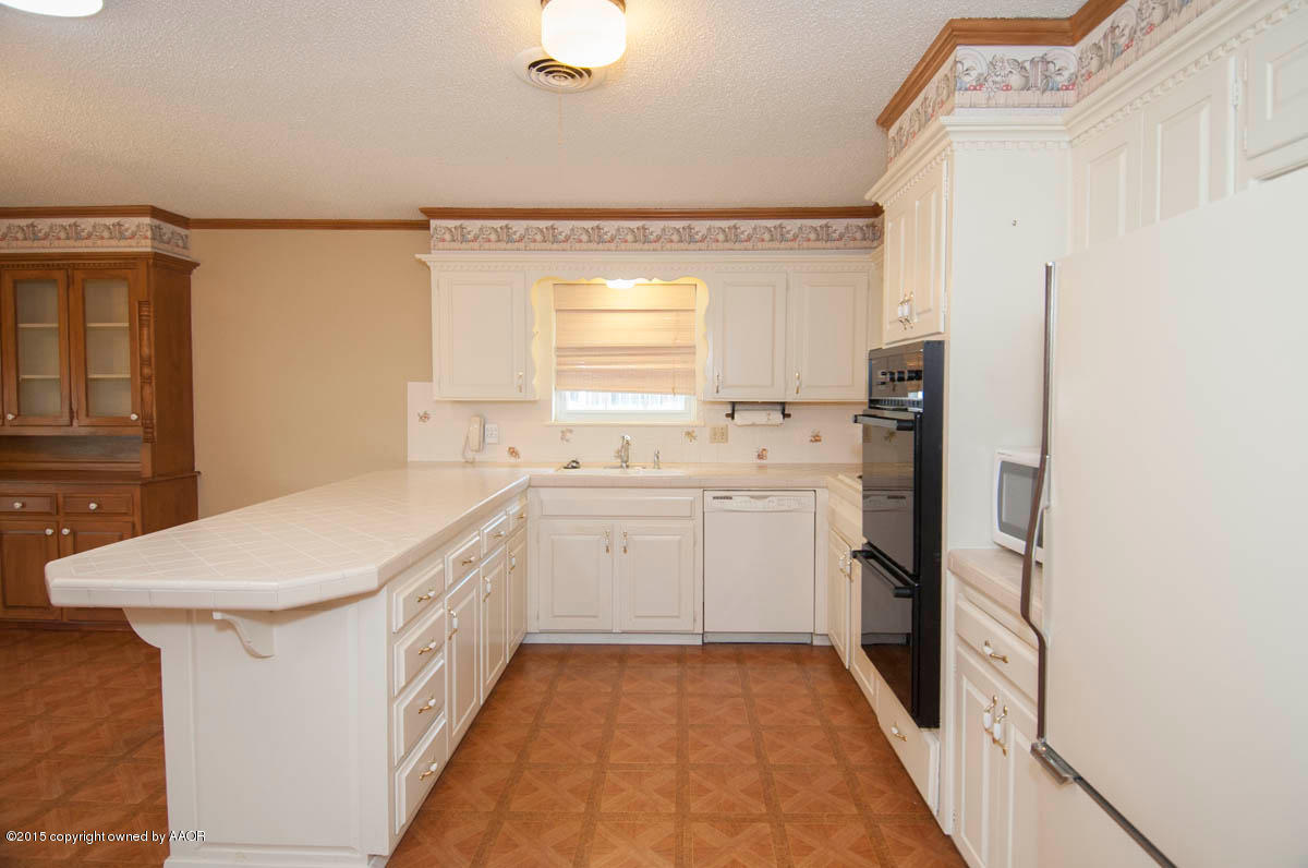 3306 Lombard Road Amarillo, TX 79106 - Photo 8 of 23 a utility room with cabinets washer and dryer