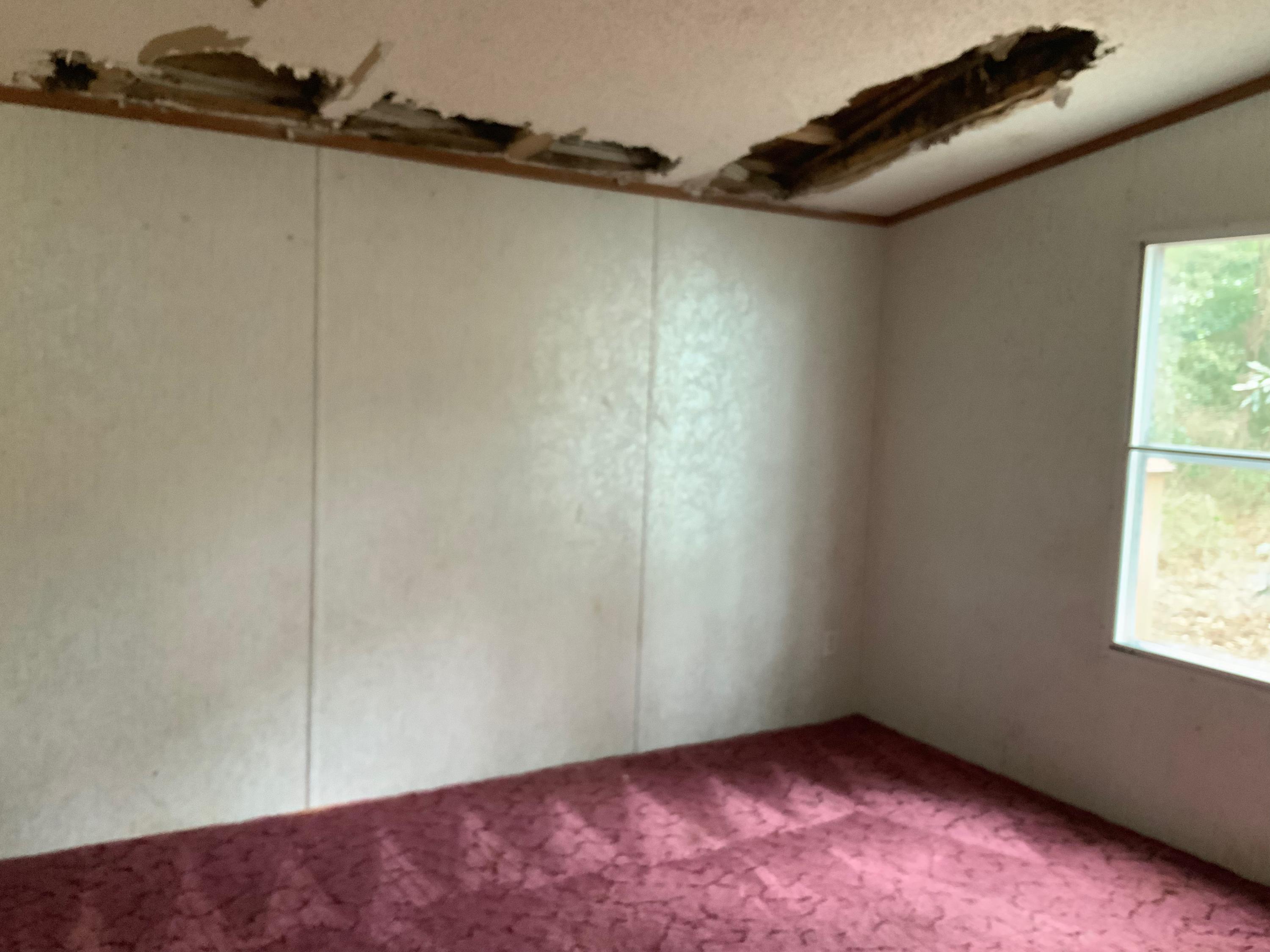 126 South 3rd Street Santa Rosa Beach, FL 32459 - Photo 11 of 12 an empty room with a wooden floor and windows