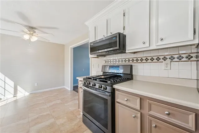 wooden floor fireplace and windows in an empty room