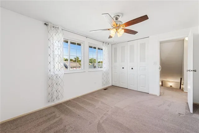 a spacious bathroom with a granite countertop sink a toilet and a mirror