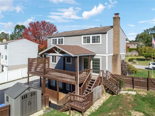 an aerial view of residential houses with outdoor space and trees