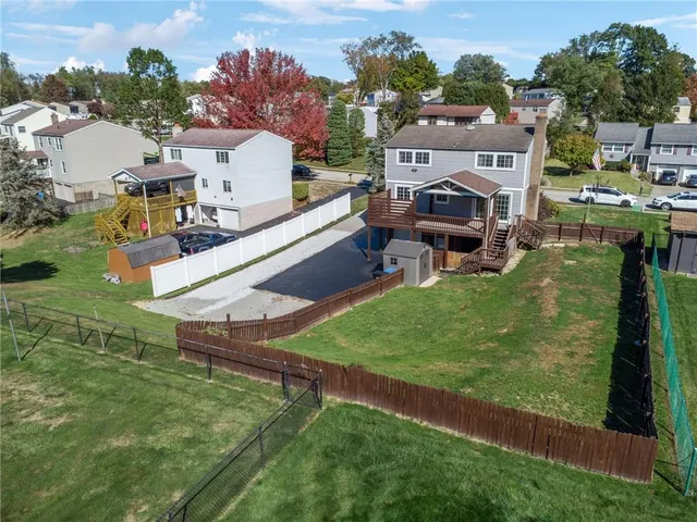 an aerial view of multiple house with yard