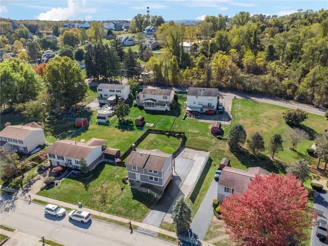 an aerial view of a house with garden space and lake view