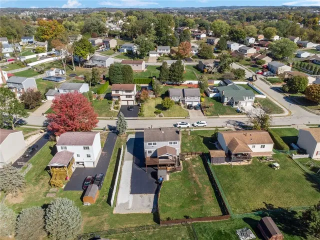 an aerial view of a house with pool lake view and mountain view