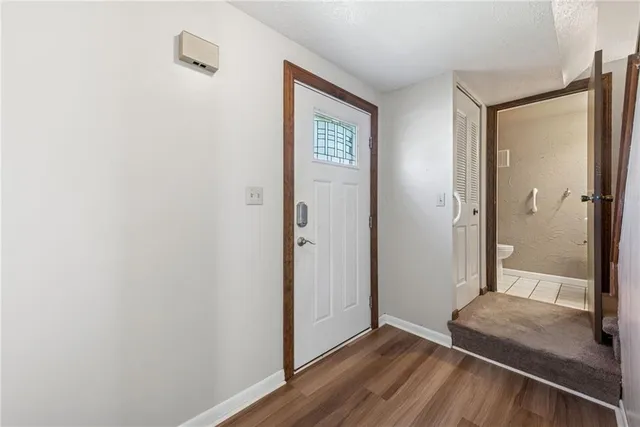 a view of a hallway with wooden floor