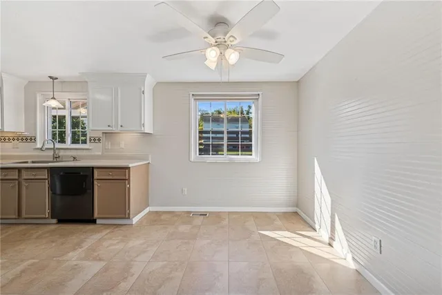 a view of kitchen with windows and ceiling fan