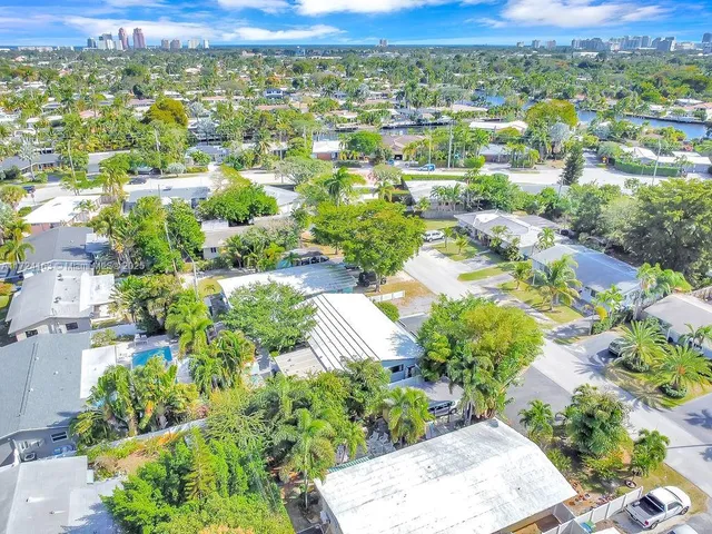 an aerial view of residential houses with outdoor space and street view