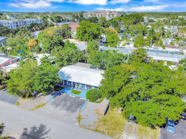 an aerial view of a house with a yard and lake view