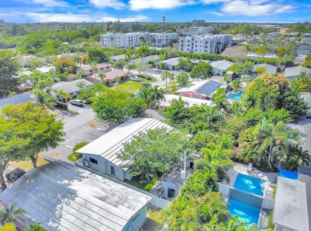 an aerial view of a houses with a yard