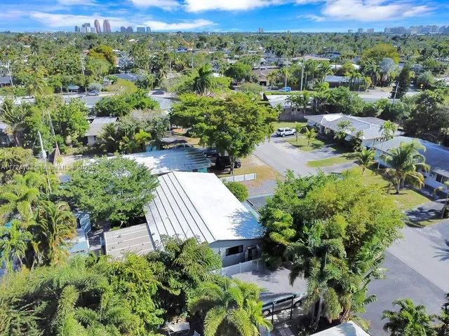 an aerial view of a house with a yard and lake view