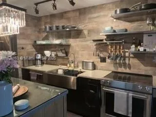 a kitchen with stainless steel appliances granite countertop a sink and a stove