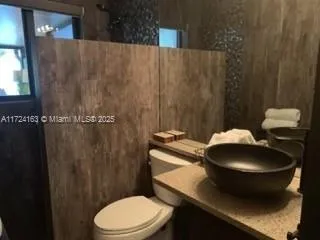 a blue white toilet sitting next to a bathroom sink
