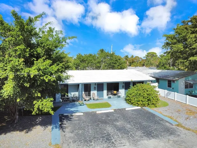 a view of house with outdoor space and sitting area