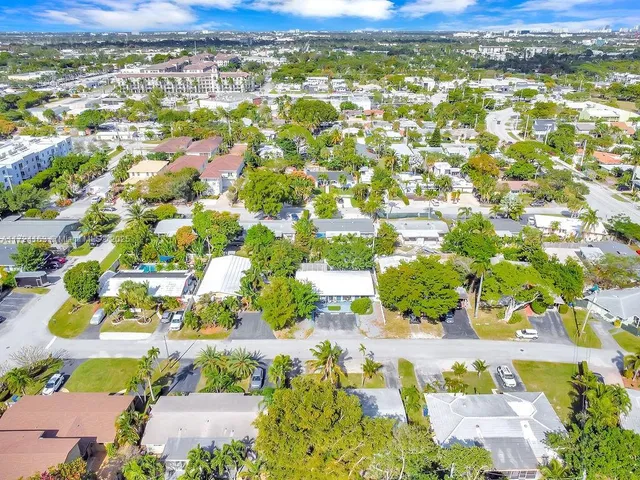 an aerial view of residential houses with outdoor space