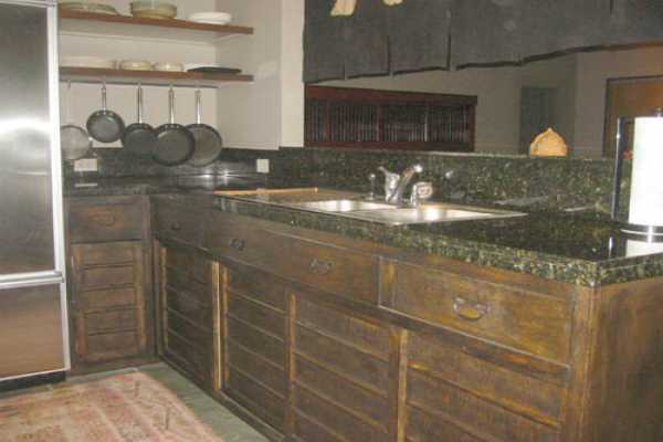 19-4023 Old Volcano Road Volcano, HI 96785 - Photo 11 of 17 a kitchen with granite countertop a sink and cabinets