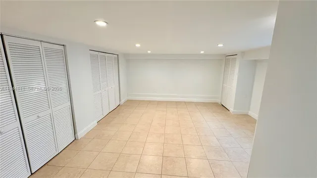 a bedroom with furniture and a flat screen tv