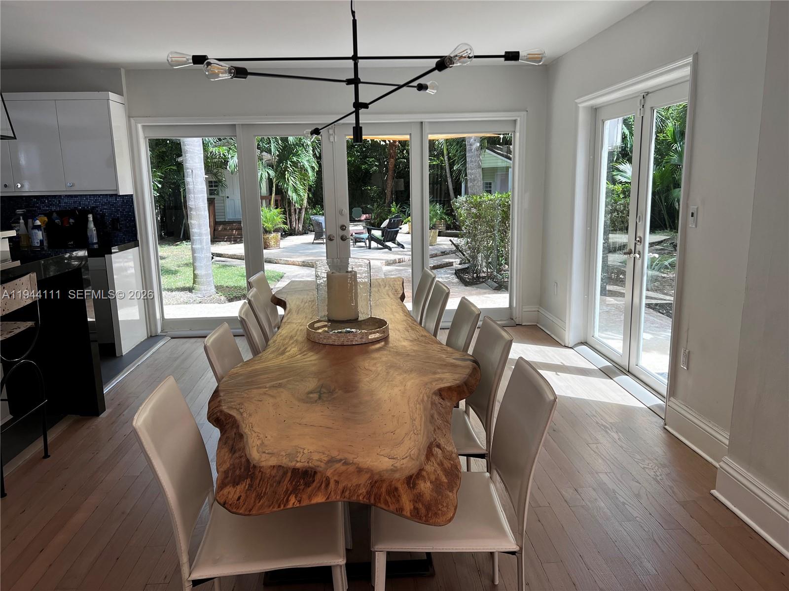 2301 South Miami Avenue Miami, FL 33129 - Photo 60 of 68 a view of a dining room with furniture wooden floor and chandelier