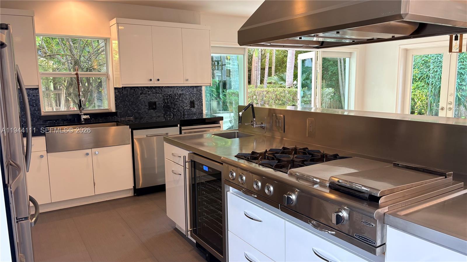 2301 South Miami Avenue Miami, FL 33129 - Photo 66 of 68 a kitchen with stainless steel appliances granite countertop a stove a sink and a microwave