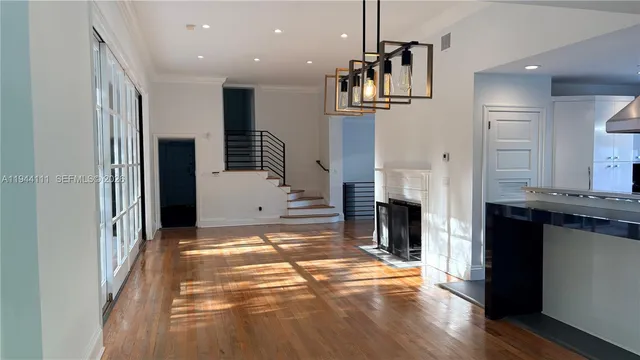 a front view of a house with a tree