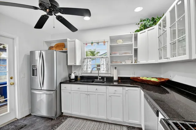 a kitchen with stainless steel appliances granite countertop a refrigerator and a sink