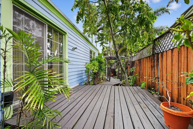 a front view of a house with a potted plant
